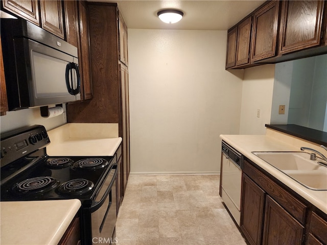 kitchen with black appliances, sink, and dark brown cabinetry