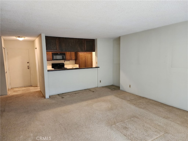 unfurnished living room featuring a textured ceiling and light carpet