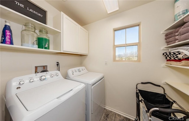 laundry area with washing machine and clothes dryer and cabinets