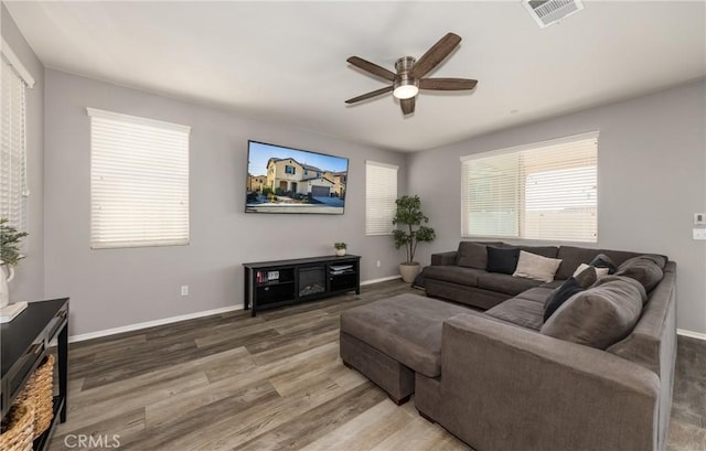 living room featuring ceiling fan and wood-type flooring