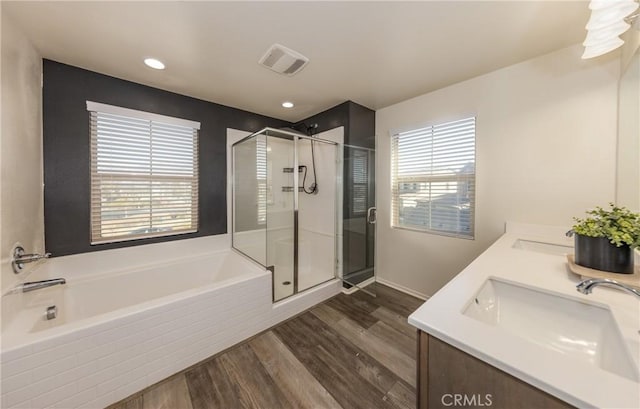 bathroom featuring shower with separate bathtub, wood-type flooring, and vanity