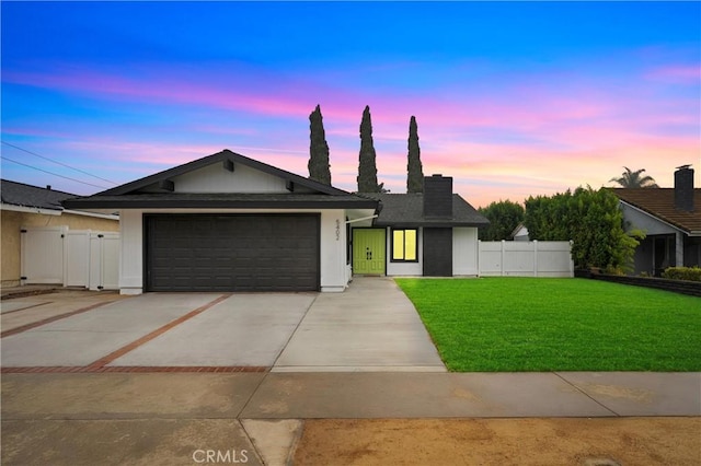 single story home with a lawn and a garage