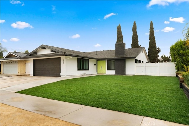 single story home featuring a front lawn and a garage