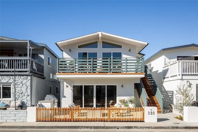 back of property featuring a balcony