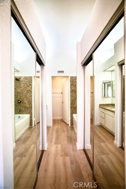 hallway with light hardwood / wood-style floors