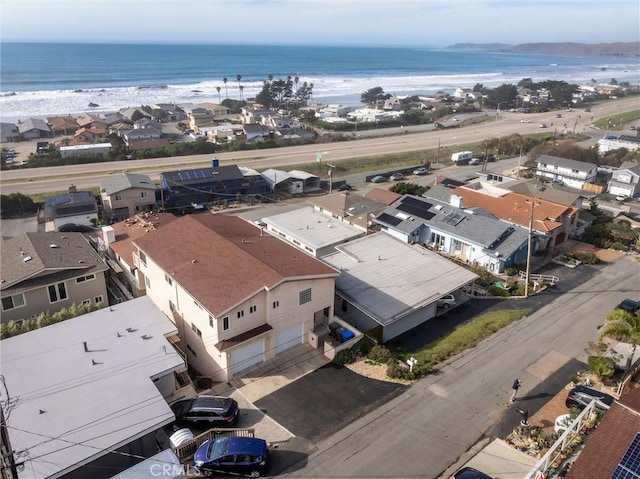 drone / aerial view with a water view and a beach view