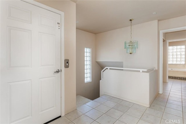 entryway featuring light tile patterned floors and an inviting chandelier