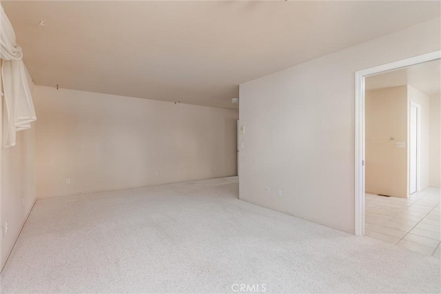 spare room with light colored carpet