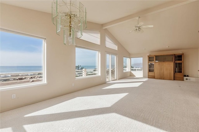 unfurnished living room with carpet, a water view, high vaulted ceiling, and beamed ceiling