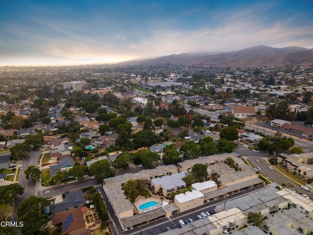 aerial view at dusk featuring a mountain view