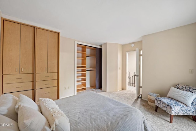 bedroom featuring a closet, baseboards, and carpet