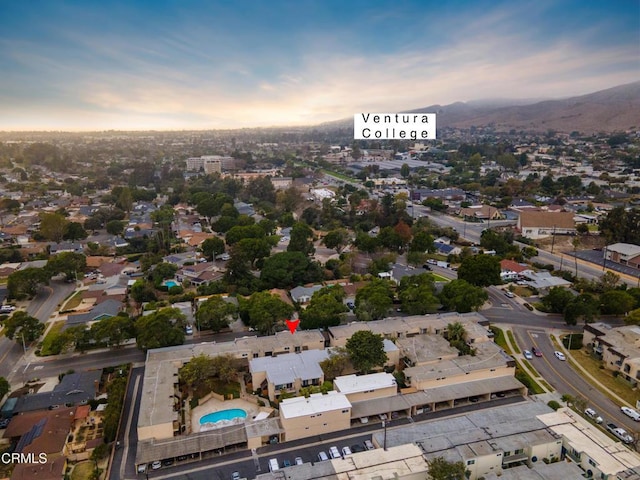 aerial view at dusk featuring a mountain view