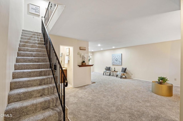stairway with recessed lighting and carpet floors