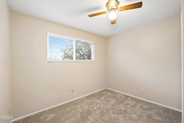 spare room with carpet floors, baseboards, and ceiling fan