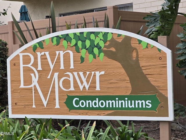 community / neighborhood sign featuring fence