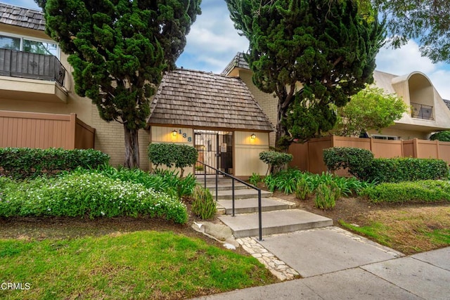 view of front of home featuring fence