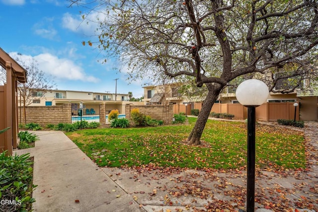 view of yard with a fenced in pool and fence