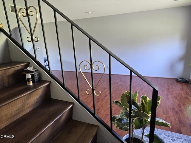 staircase with wood-type flooring