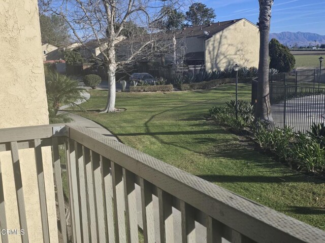 view of yard with a balcony and a mountain view