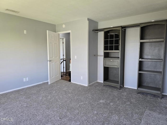 unfurnished bedroom with dark carpet