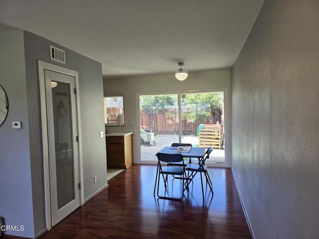 dining area featuring dark hardwood / wood-style floors