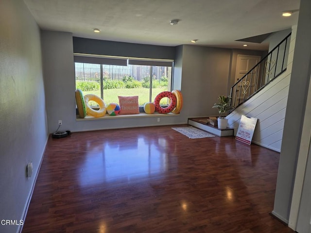 workout area with dark wood-type flooring