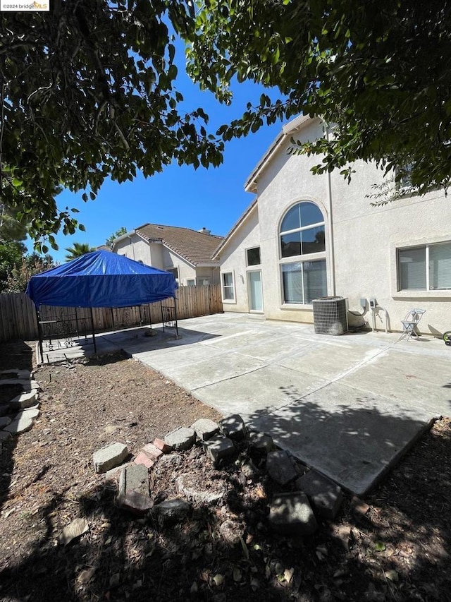 back of house with cooling unit and a patio