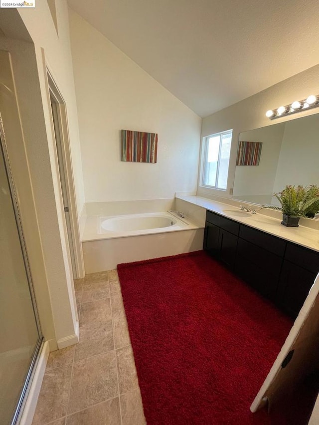 bathroom featuring lofted ceiling, vanity, and independent shower and bath