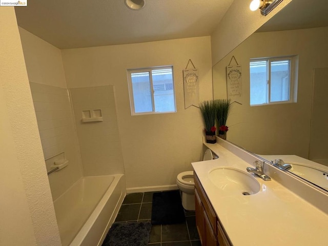 full bathroom featuring plenty of natural light, toilet, vanity, and tile patterned flooring