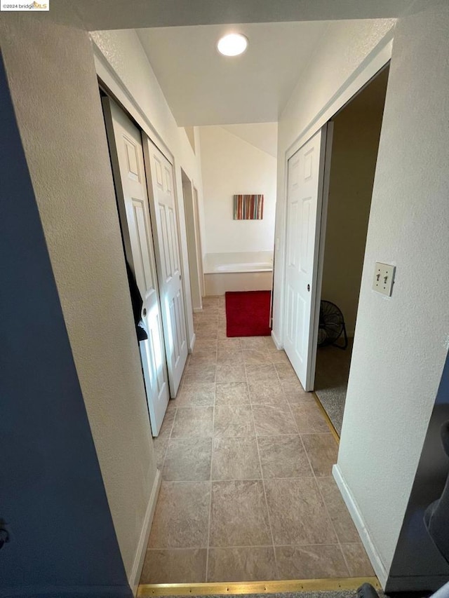 corridor featuring light tile patterned floors