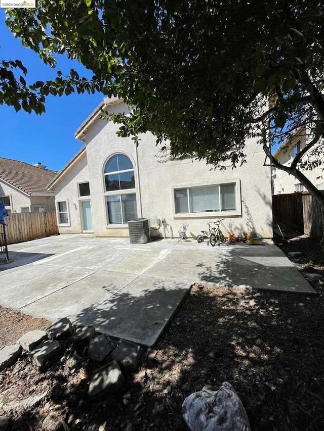 rear view of property featuring cooling unit