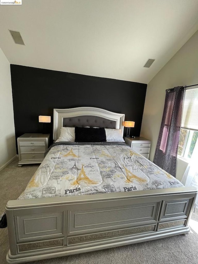 carpeted bedroom with vaulted ceiling