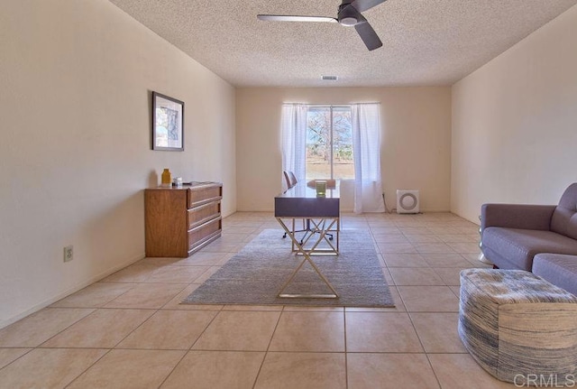 office space with ceiling fan, a textured ceiling, and light tile patterned floors