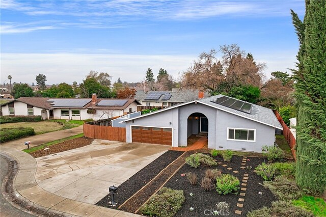 single story home featuring a garage and solar panels