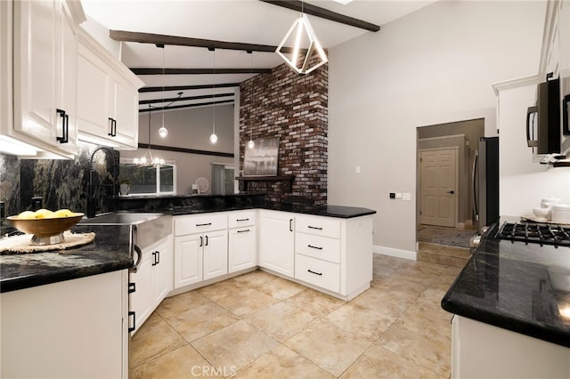 kitchen featuring stainless steel refrigerator, decorative light fixtures, beamed ceiling, white cabinets, and kitchen peninsula