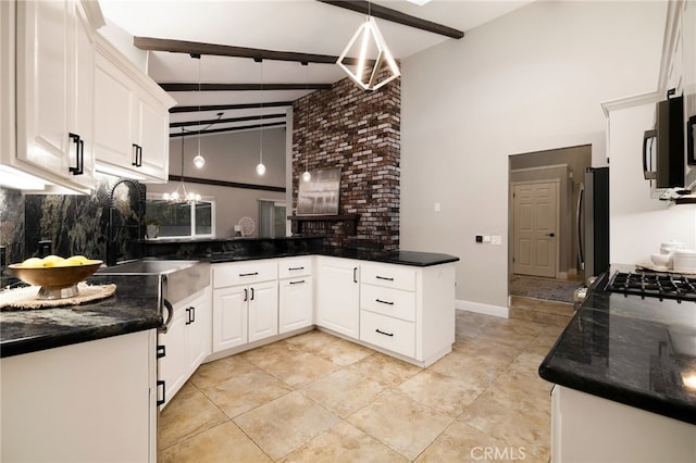 kitchen with stainless steel fridge, hanging light fixtures, white cabinets, kitchen peninsula, and beamed ceiling