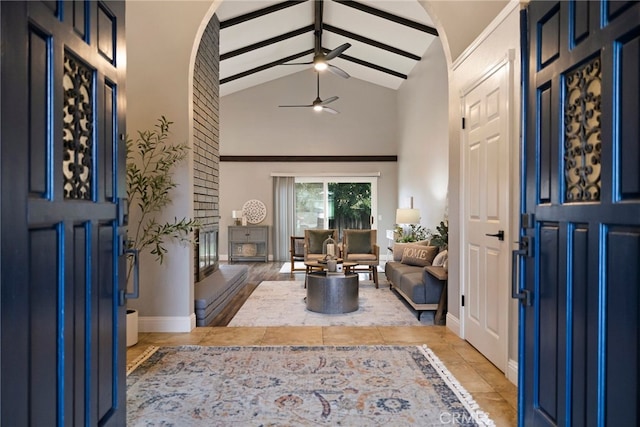 foyer entrance featuring ceiling fan, beam ceiling, and high vaulted ceiling