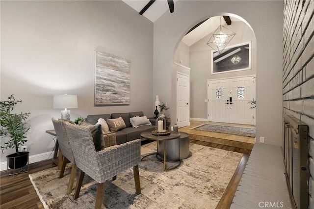 living room with a towering ceiling and dark hardwood / wood-style floors