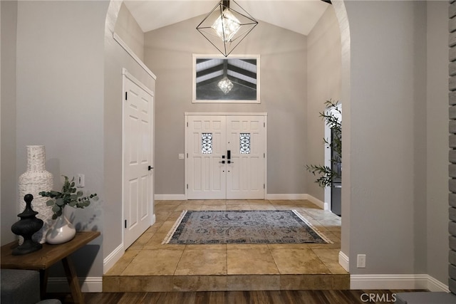 foyer entrance featuring high vaulted ceiling