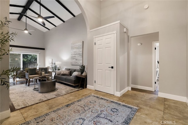 living room with beam ceiling, high vaulted ceiling, and ceiling fan