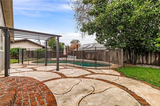 view of swimming pool with a patio area and a pergola