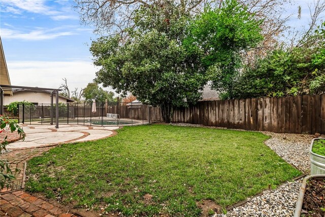 view of yard with a swimming pool and a patio area