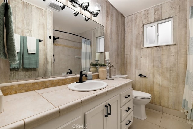 bathroom with tile patterned flooring, vanity, a shower with shower curtain, and toilet