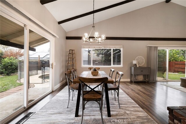 dining area with high vaulted ceiling, a chandelier, and hardwood / wood-style floors