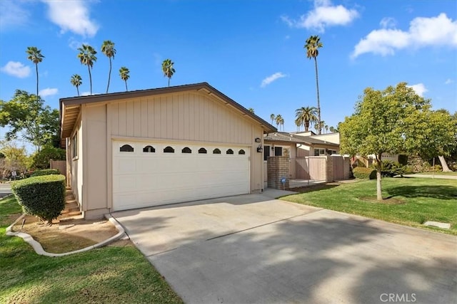 view of front of home with a front yard and a garage