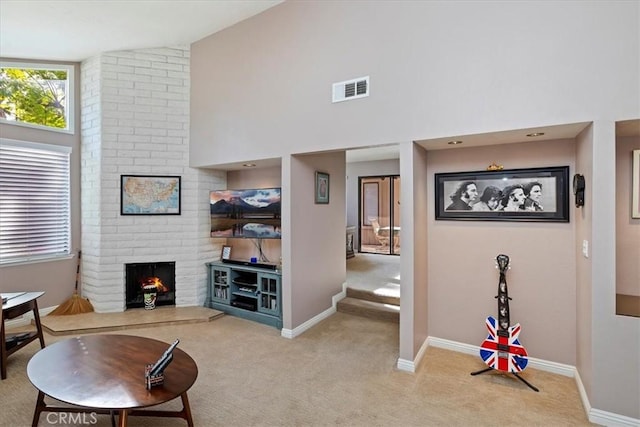 carpeted living room featuring high vaulted ceiling and a fireplace