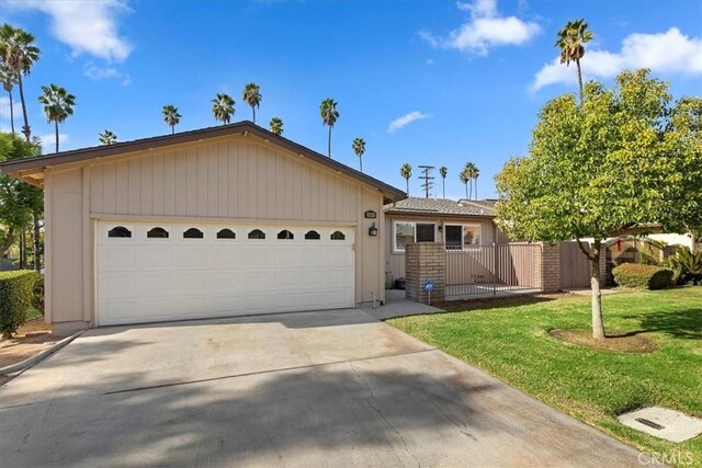 single story home with a front yard and a garage