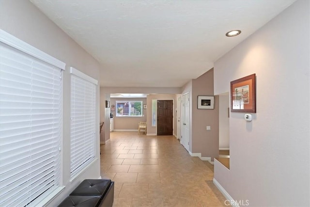 hallway featuring light tile patterned floors