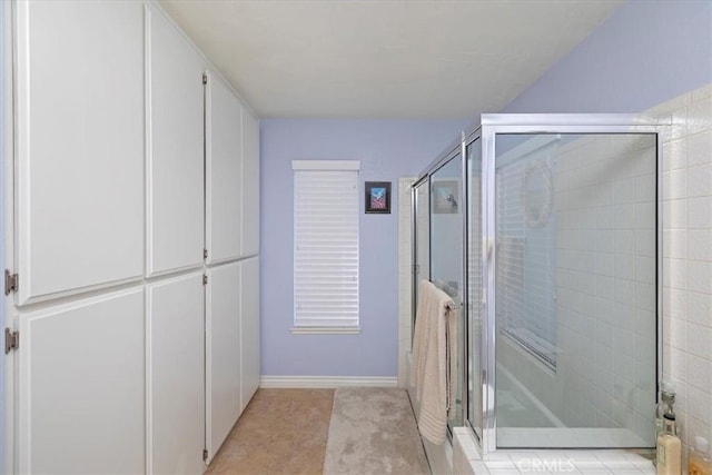 bathroom featuring tile patterned flooring and a shower with door