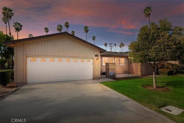 ranch-style home with a lawn and a garage